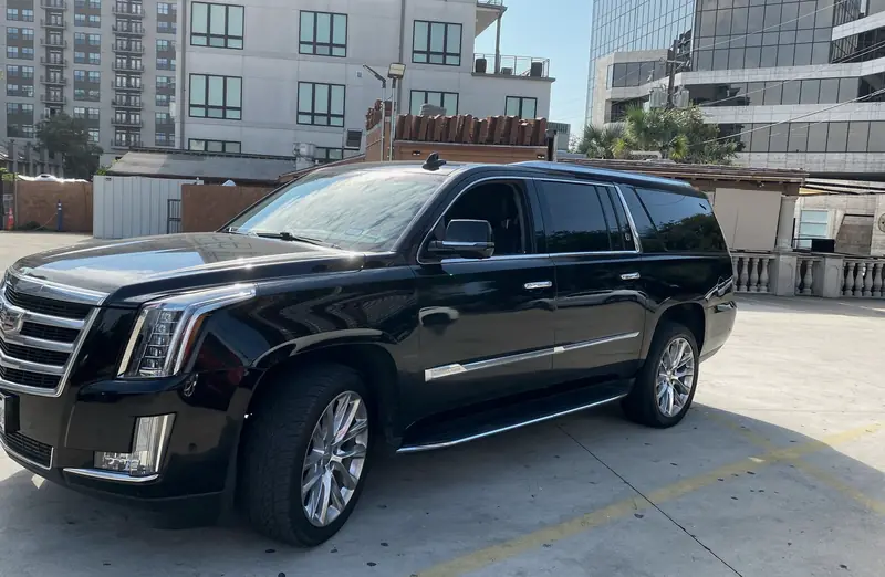 A black Cadillac Escalade SUV parked in Dallas.